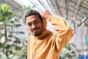 Lifestyle photo of a person wearing a modern hoodie outdoors—great for showcasing custom embroidered hoodies.