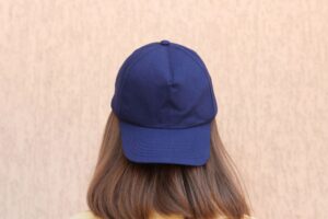 Lifestyle photo of a person wearing a neutral baseball cap (ideal for showcasing custom embroidery).