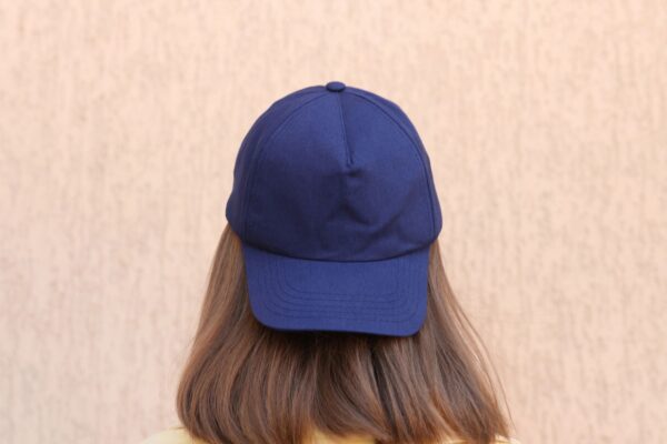 Lifestyle photo of a person wearing a neutral baseball cap (ideal for showcasing custom embroidery).